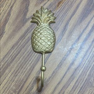 Gold Pineapple Wall Hook which could be cast iron. It is heavy.